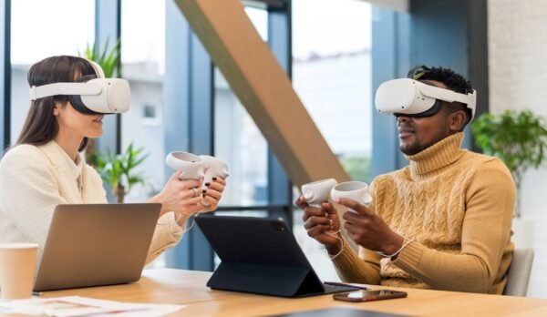 Business conference in VR in an office Business conference in VR in an office. A black man and caucasian woman using VR glasses and controllers, papers and gadgets on the table