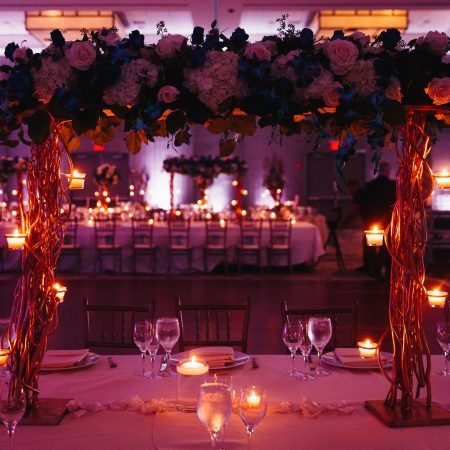 Beautiful pink decorated wedding serving with centerpiece and lightening candles