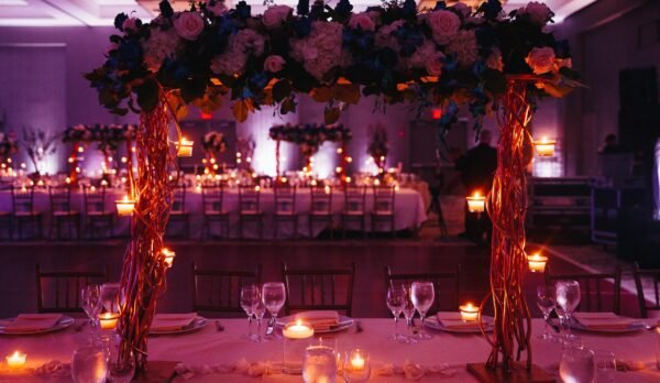 Beautiful pink decorated wedding serving with centerpiece and lightening candles